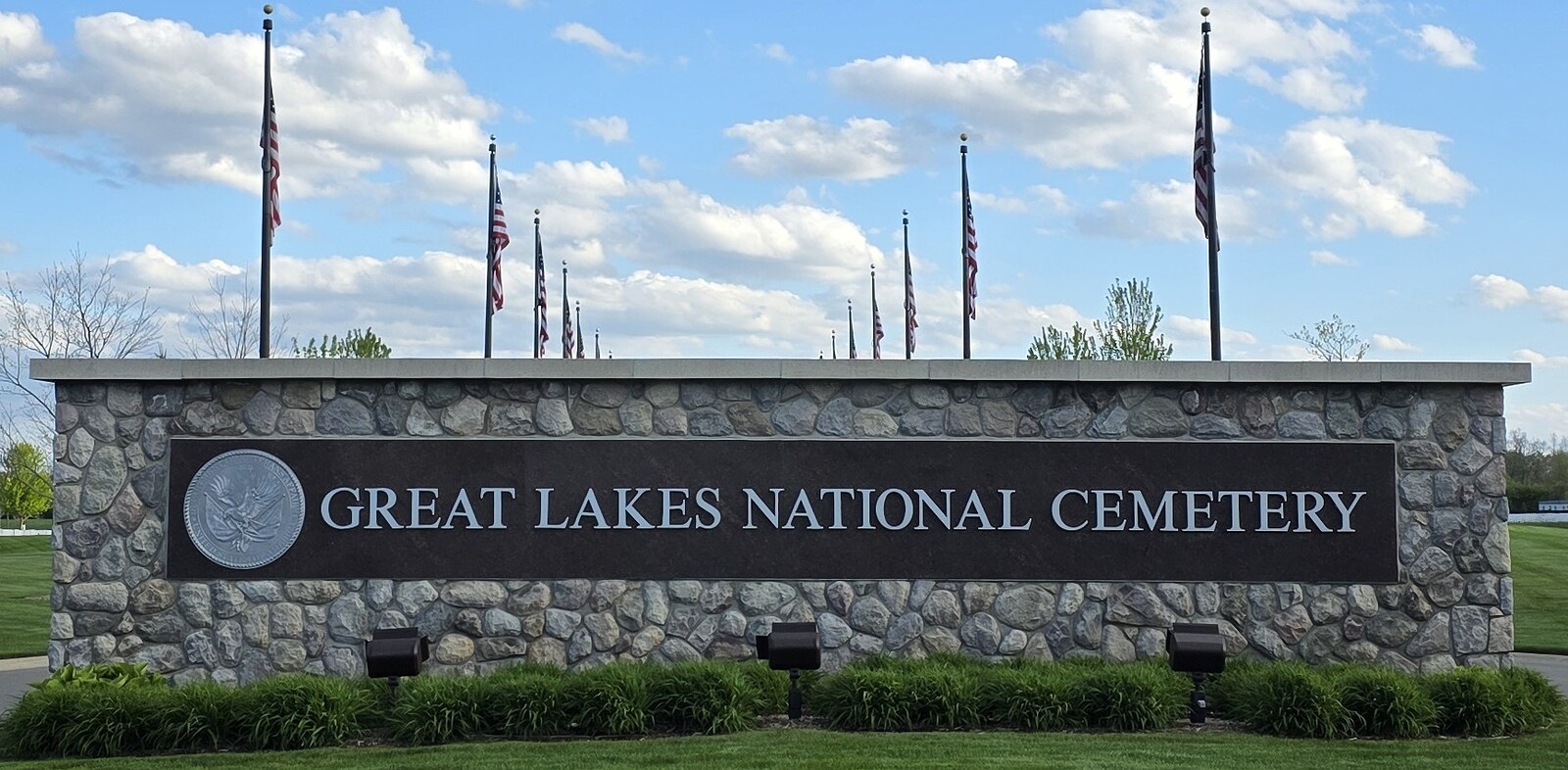 Great Lakes National Cemetery entrance sign with American flags